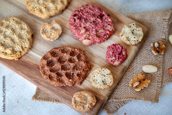 Fototapeta Oat cookies with  nuts and seeds on shadows background