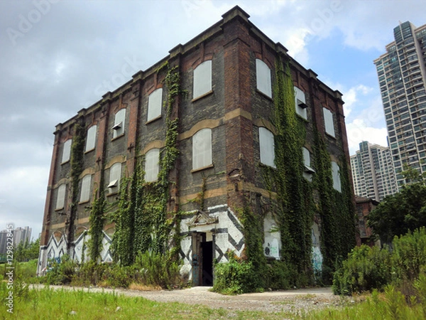 Obraz Abandoned brick building with spray paint graffiti 