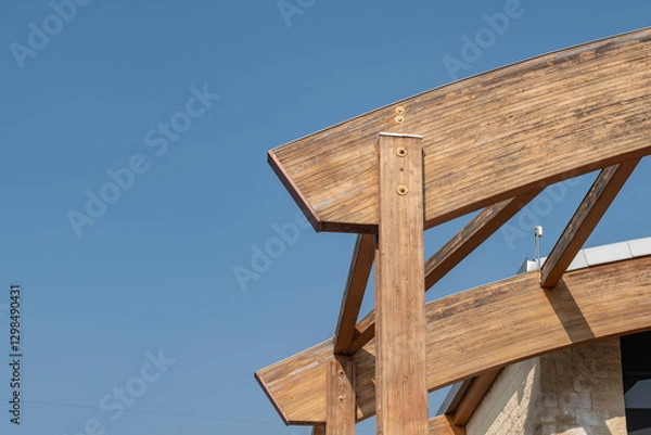 Fototapeta glulam with signs of wear due to time and weather. structure with arched beams and supporting pillars. commercial building designed with structural exposed modules. project, glued laminated timber