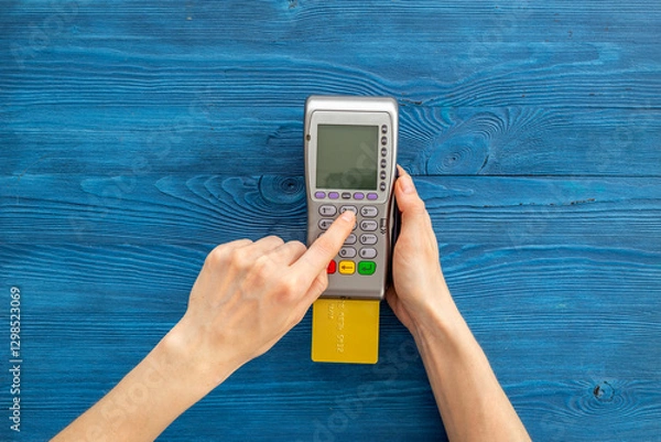 Fototapeta Female holding in hands bank terminal for contactless payment by credit cards. Banking and shopping concept