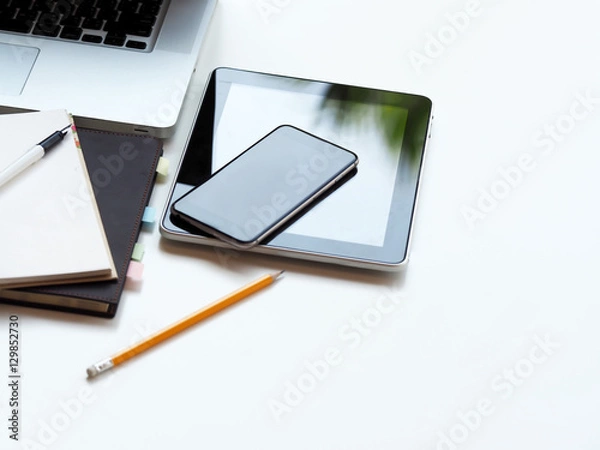Fototapeta business equipment with mobile phone, tablet, computer, notebook, pen, pencil on workplace