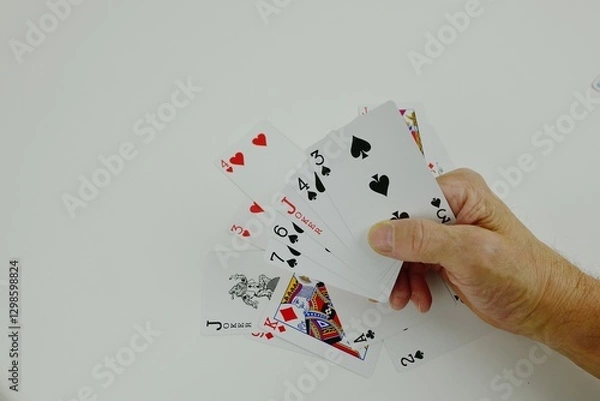 Obraz Poker cards scattered on the table and in my hand.