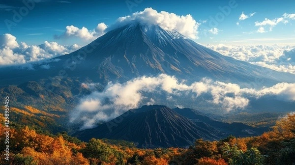 Obraz Majestic volcano peak with autumn foliage and clouds.