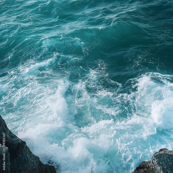 Fototapeta Ocean waves crashing against rocks. Turquoise water, white foam.