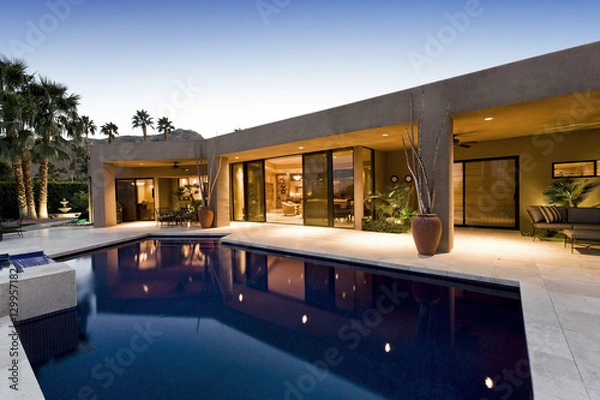 Fototapeta View of swimming pool in front of a modern house against clear sky