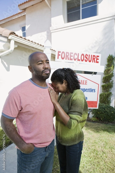 Fototapeta Multiethnic bankrupt couple moving out of house