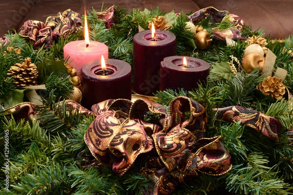 Fototapeta Traditional Advent wreath on rustic table with candles glowing warm