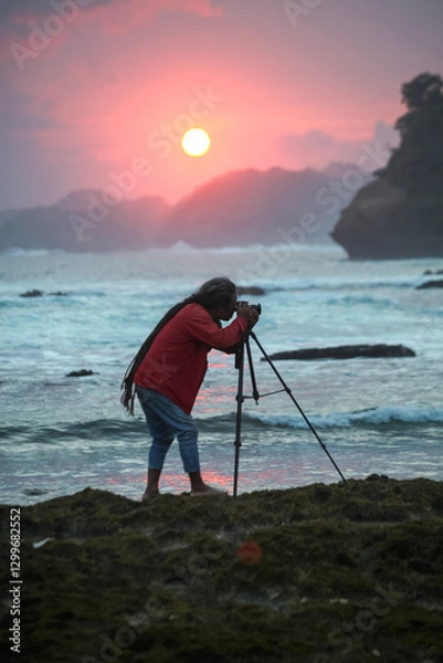 Obraz Photographer on the beach at sunset in Java Indonesia Ngliyep beach