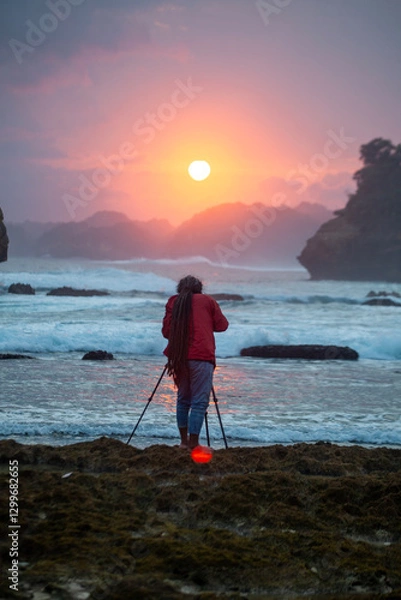 Obraz Photographer on the beach at sunset in Java Indonesia Ngliyep beach