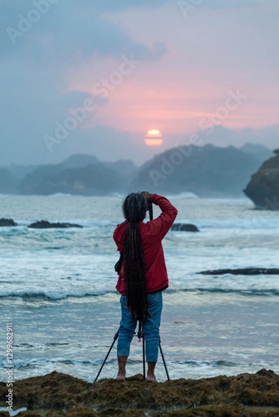 Obraz Photographer on the beach at sunset in Java Indonesia Ngliyep beach