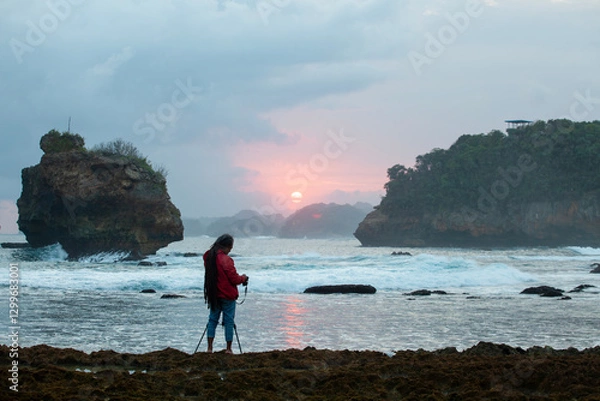 Obraz Photographer on the beach at sunset in Java Indonesia Ngliyep beach