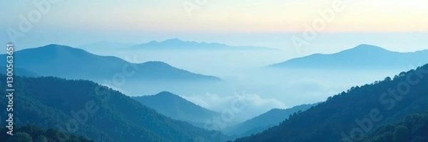 Fototapeta Soft blue fog rolling over the hills with fluffy white clouds, landscape, atmospheric