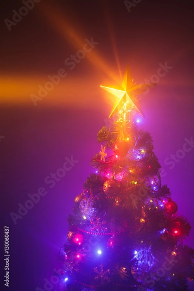 Fototapeta Christmas tree with shining star and dense smoke
