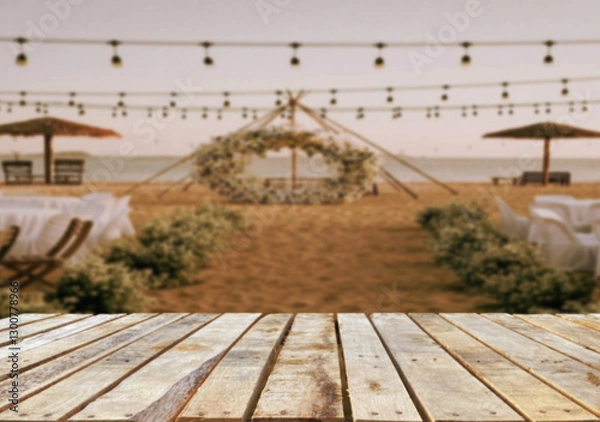 Obraz Wooden table top on blur restaurant or party wedding on the beach background.For montage product display or design key visual layout.View of copy space.
