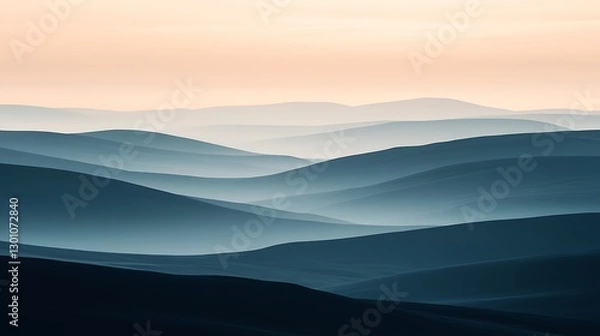 Fototapeta The Mountain Range Displays a Subtle Blue Misty Landscape at Sunset