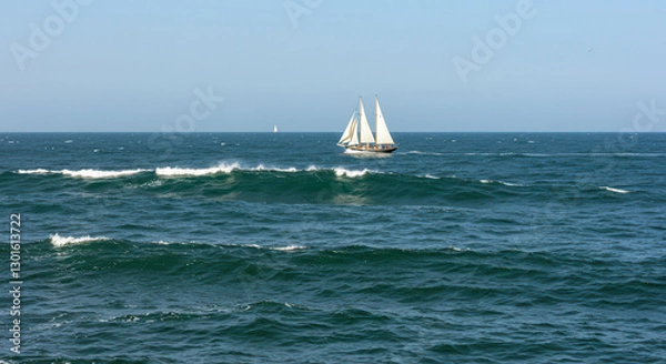 Fototapeta Sailboat on the Ocean with Blue Sky and Waves in a Scenic Summer Seascape