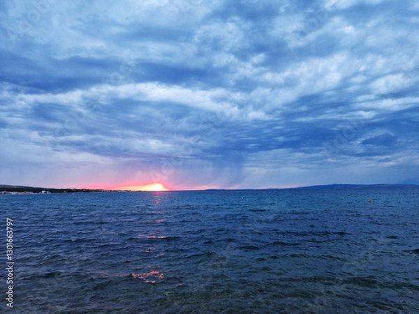 Obraz Dramatic seascape at sunset with stormy clouds and glowing horizon