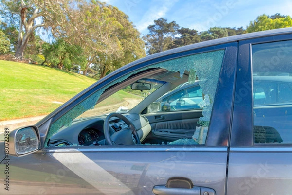 Fototapeta SAN FRANCISCO, CALIFORNIA - CIRCA OCTOBER, 2021: Close up view of the broken glass window of a car because of theft crime