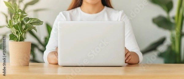 Fototapeta Woman using laptop computer at home office desk working remotely home workspace