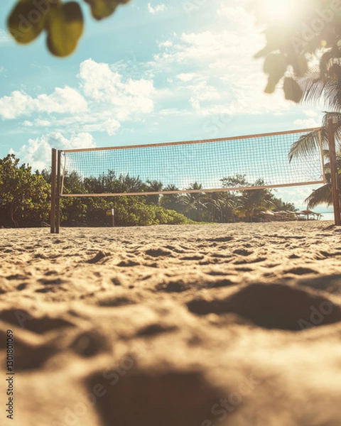 Fototapeta sandy beach with volleyball net under bright sky, surrounded by lush greenery, creates perfect setting for outdoor sports and relaxation