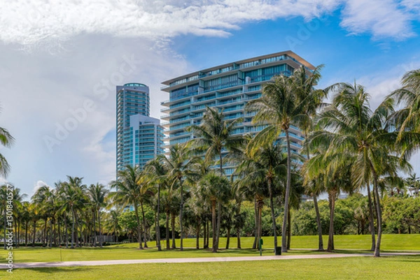 Fototapeta MIAMI, FLORIDA - CIRCA JULY, 2022: South Pointe Park with grass field and coconut trees