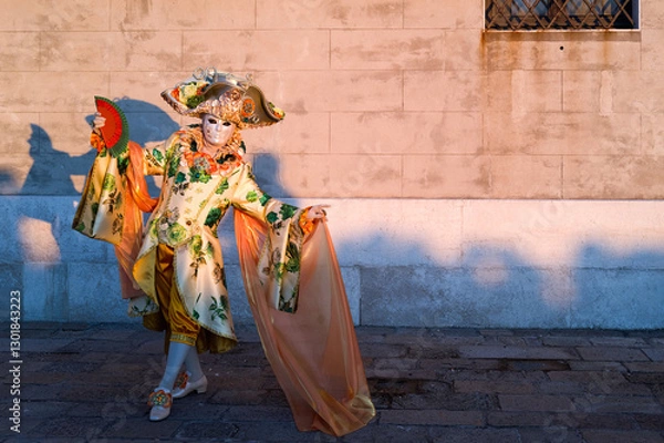 Obraz Venice, Italy - People dressed in carnival masks are photographed by tourists in the scenery of the ancient Venetian palaces
