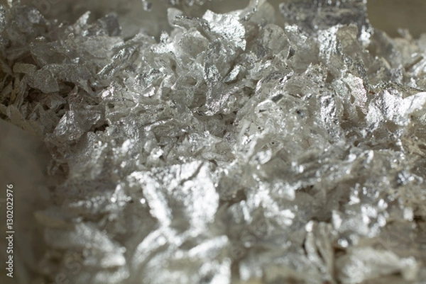 Fototapeta A closeup view of a pile of silver leaf sheet flakes.