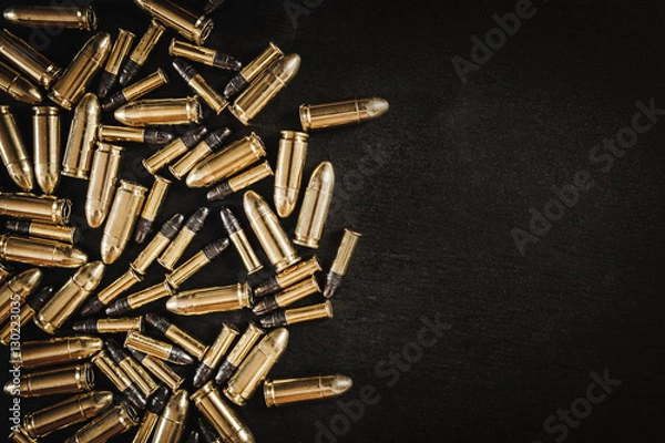 Obraz bullets from the gun placed on a black wooden table