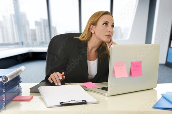 Obraz businesswoman working at laptop computer sitting on the desk absent minded