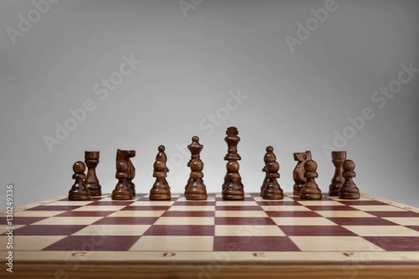 Fototapeta Chessboard with chess pieces. Black set, front wide view angle.