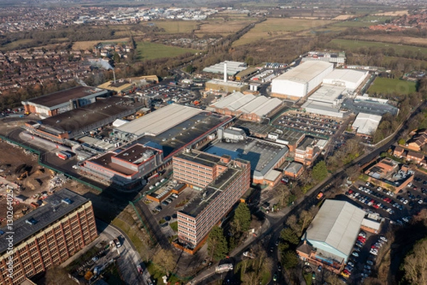 Fototapeta Aerial drone photo of the city of York in North Yorkshire, England showing the large Nestle chocolate factory in the city showing the large building surrounded by houses and homes in the winter time