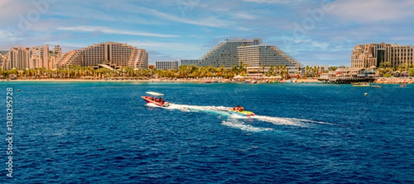 Obraz Water sport activities and resting on the Red Sea. Panoramic view on central public beach of Eilat – famous tourist resort city in Israel. My own photo. Traditional digital enhancement tools were used