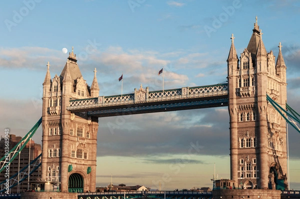 Fototapeta Tower Bridge in London at sunset with moon behind the clouds