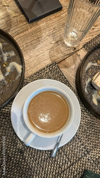 Obraz A white cup with a small saucer of coffee.