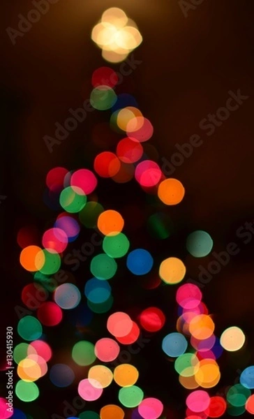 Fototapeta Colorful bokeh background in the shape of a Christmas tree