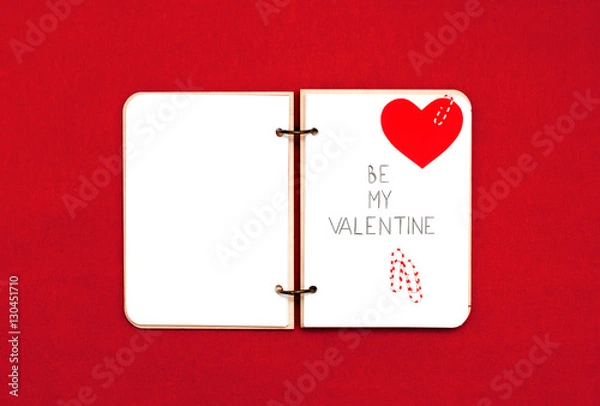Obraz Opened blank notepad on red background. Valentine's hart