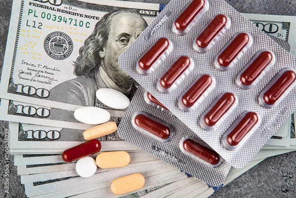 Fototapeta Pills and capsules on the background of the dollar. The concept of expensive medicine.