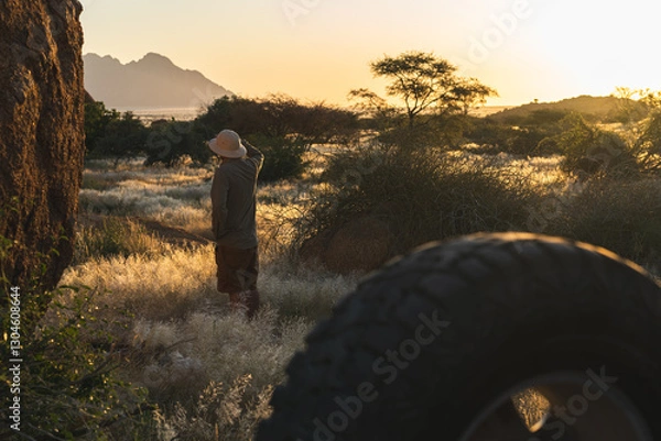 Obraz A safari explorer in the wilderness of Namibia around Spitzkoppe, watching the nature at sunset. 