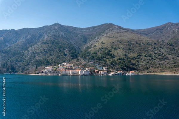 Fototapeta View of a small town with a backdrop of mountains in Kotor bay, Montenegro