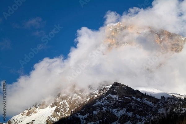 Fototapeta clouds over the snow covered mountains