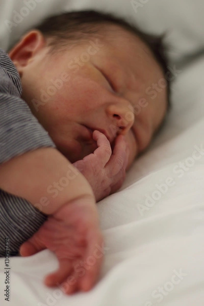Fototapeta Sweet newborn little baby lying on the bed just two days after arrival.