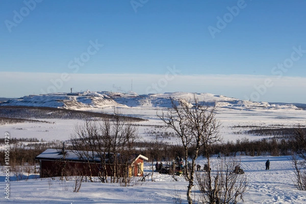 Obraz Stunning sunset view over Kiruna city and mine with snow covered trees in Swedish Lapland