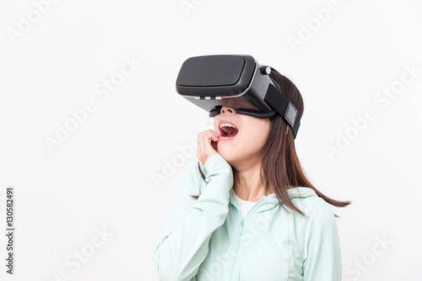 Fototapeta Young woman feeling scary watching with virtual reality device
