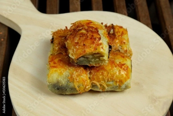 Fototapeta Banana Bolen Wrapped in Puff Pastry is a typical Indonesian baked bread cake with baked flour with margarine filled with chocolate and banana.