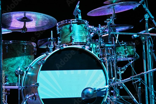 Fototapeta Backlighted drum set with bass drum, tom-toms, cymbals and microphones