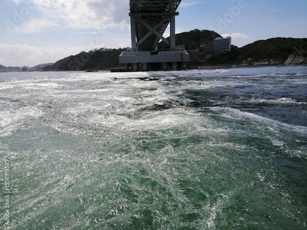 Fototapeta It says "Naruto" in Japanese. In the Naruto Strait, Tokushima Prefecture, Japan, the ocean creates swirling waves due to special tidal currents.