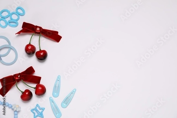 Fototapeta Different hair accessories on light background, flat lay. Space for text
