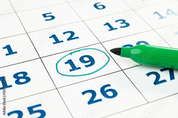Obraz Marking date in a monthly planner.