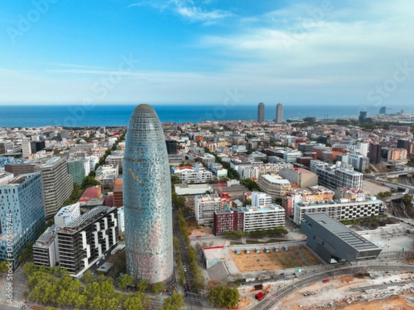 Obraz Facade tall metal tower residential buildings city blocks boulevards with green trees in summer on sunny day sunrise on lens flares. Go Everywhere 