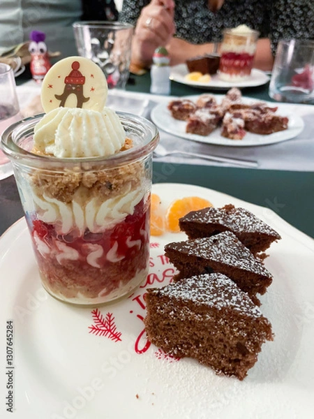 Obraz Dessert im Gläschen mit Sahne, Beerenmousse und Hafercrunch, auf einem Teller mit Gewürzkuchen in Tannenbaum Form serviert